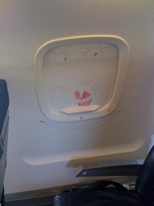 Clown face drawn on inside of window shade in row 8